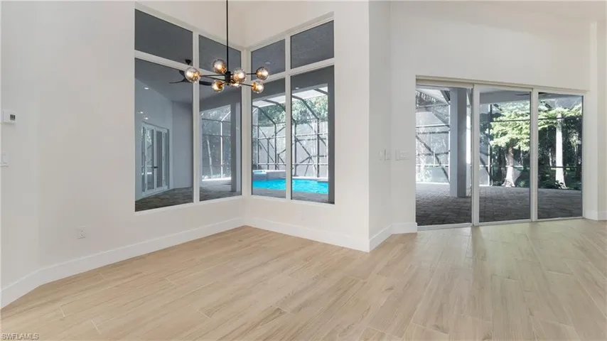 Unfurnished dining area with light wood-type flooring and a chandelier