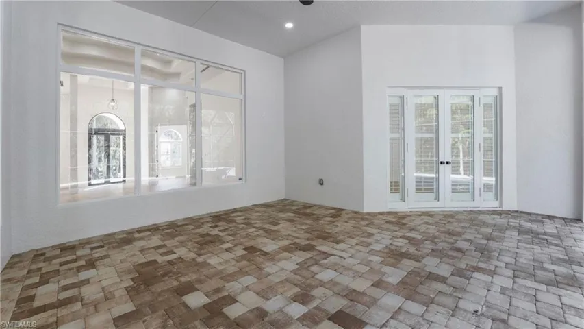 Spare room featuring brick patterned flooring