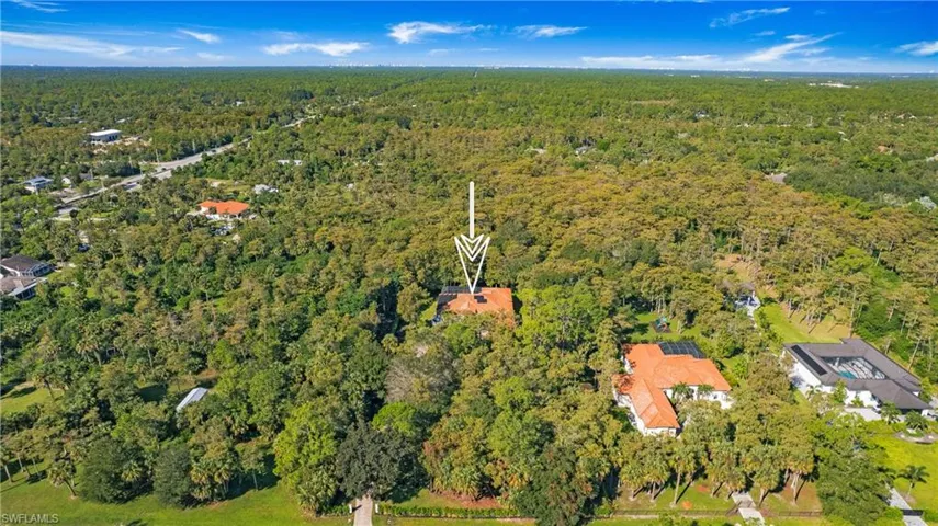 Aerial overview of property's location with a heavily wooded area