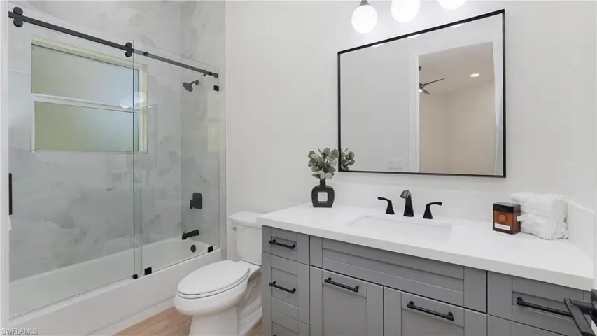Full bath 2 with combined bath / shower with glass door and vanity
