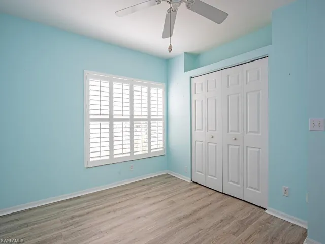 Guest Bedroom with LTV flooring and plantation shutters