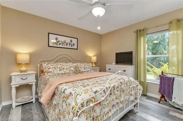 Bedroom with ceiling fan and hardwood / wood-style floors