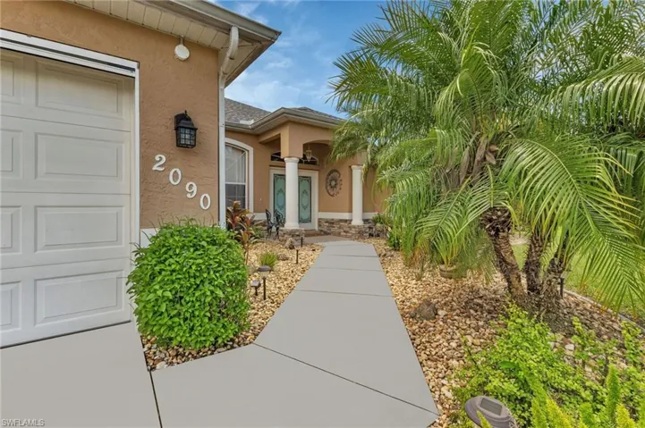 View of exterior entry with a garage