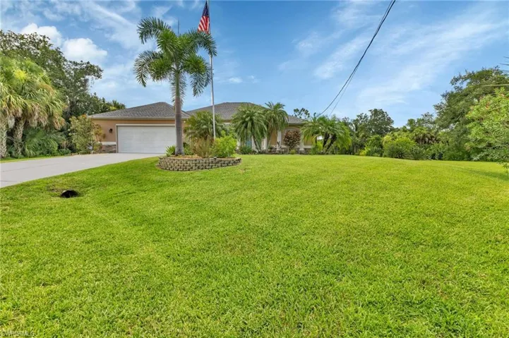 View of front of home featuring a garage and a front yard