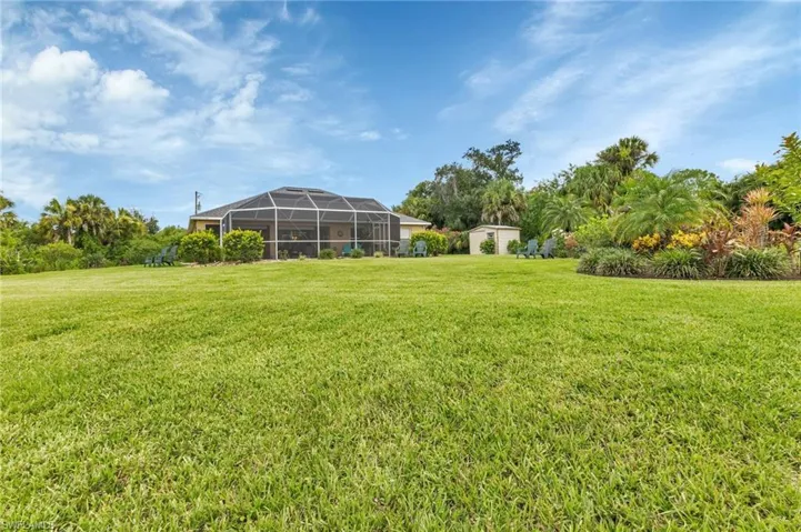 View of yard featuring glass enclosure
