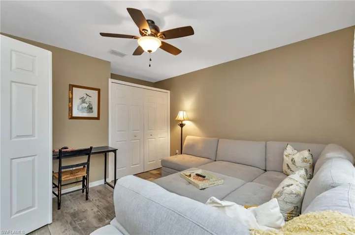 Living room featuring light wood-type flooring and ceiling fan
