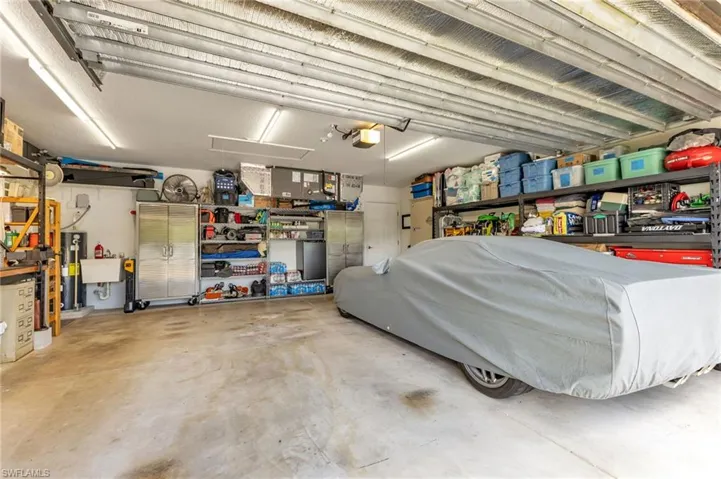 Garage featuring a garage door opener and sink