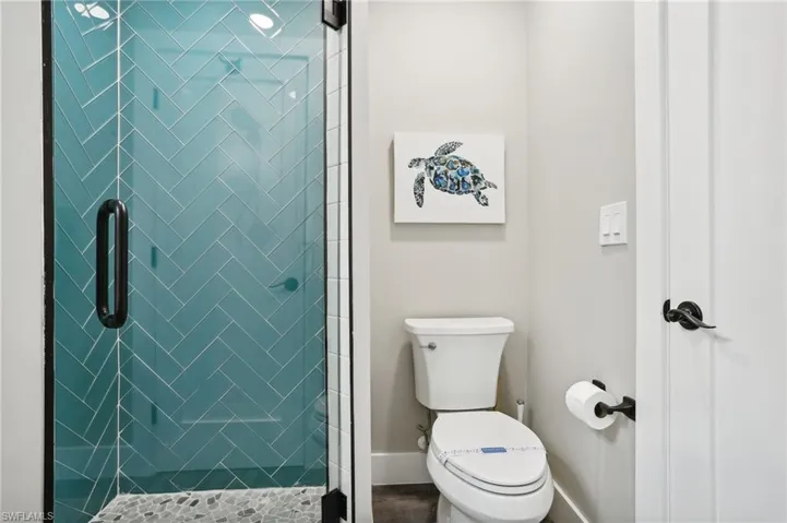 Bathroom featuring walk in shower and toilet