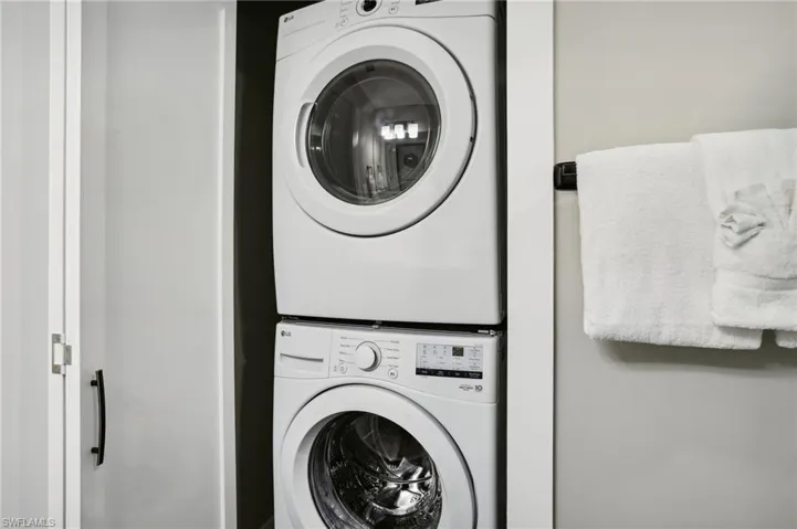 Washroom with stacked washer / drying machine