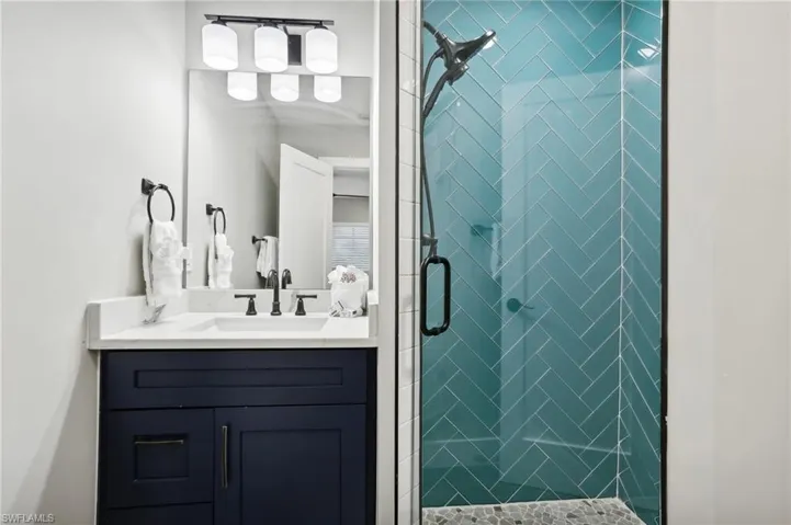 Bathroom with vanity and an enclosed shower