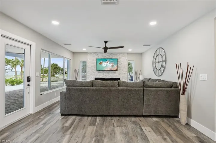 Living room with ceiling fan and wood-type flooring