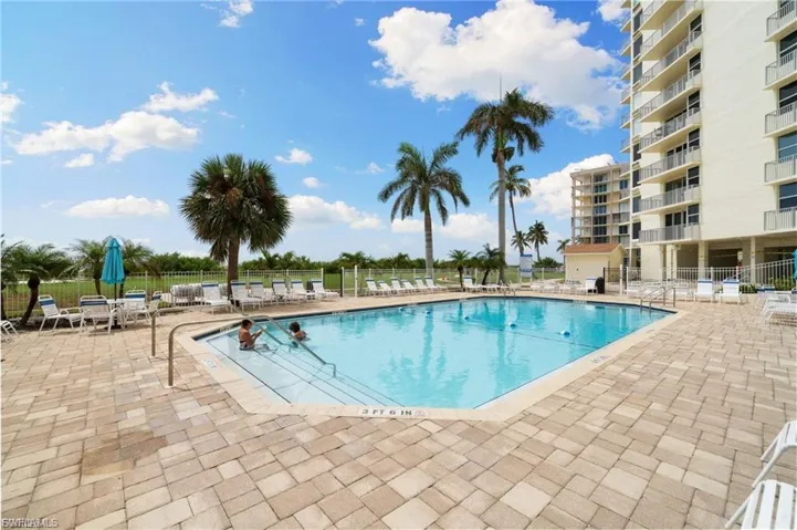 Community pool with a patio area