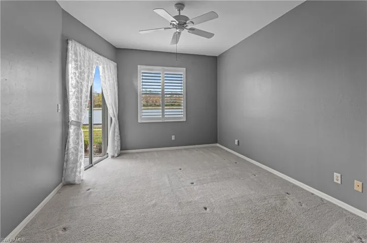 Primary Bedroom with sliders to patio and a lake view
