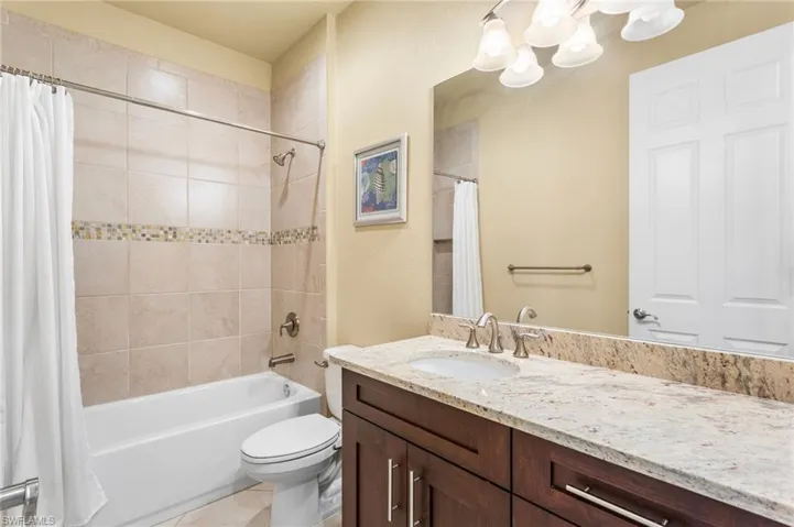 Third Bathroom with tub/shower combo and granite top vanity.