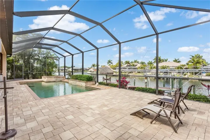 Large screen enclosed  paver pool deck and sunning area.