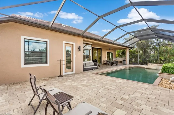 View of pool area with impact resistant window to guest bedroom on left.