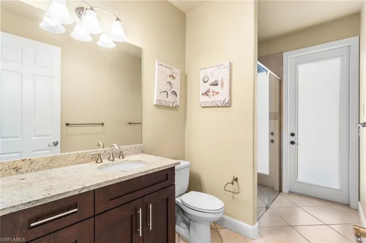 Second Bathroom/Pool Bathroom with granite top vanity and a walk-in shower.