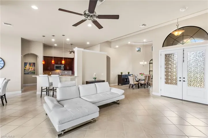 View of Great Room towards front door, Formal Dining Room and Kitchen.