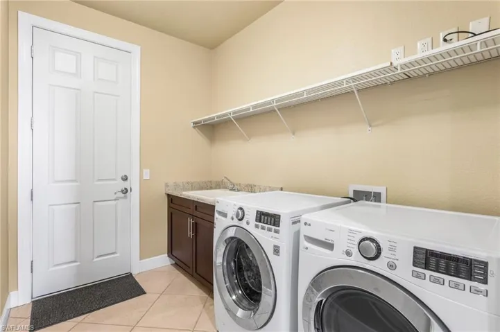Indoor Laundry Room with sink. Door to garage on left.
