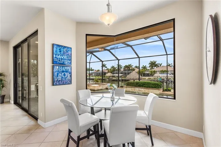 Kitchen dining nook overlooking the pool and Gulf access canal.
