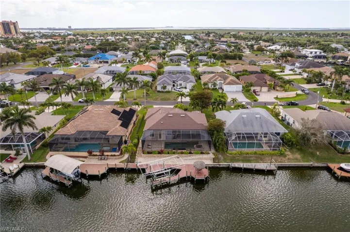 Aerial view of back of home and 150 foot wide Gulf access canal.