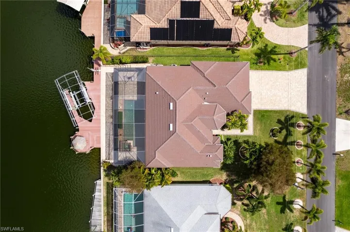 Aerial view from above the home. There is a boat lift cover stored in garage.