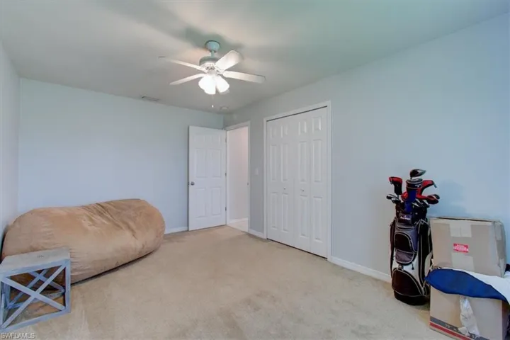 Sitting room with a ceiling fan and carpet floors