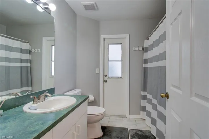 Full bath featuring tile patterned floors and vanity