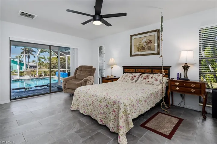 Primary Bedroom featuring access to outside and ceiling fan