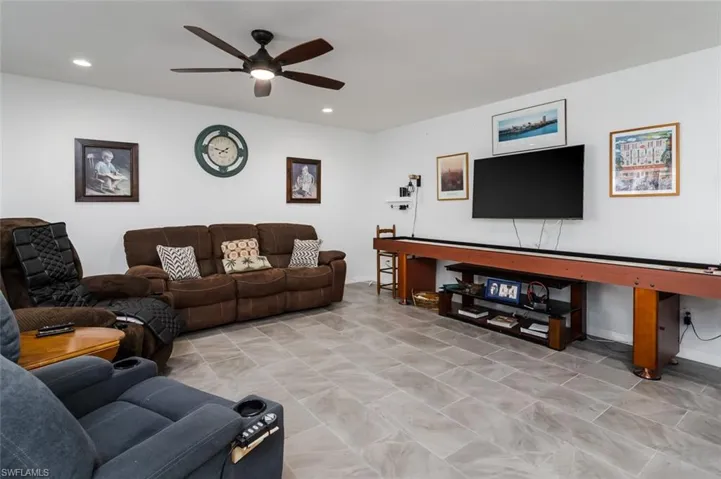 Living area featuring ceiling fan and recessed lighting