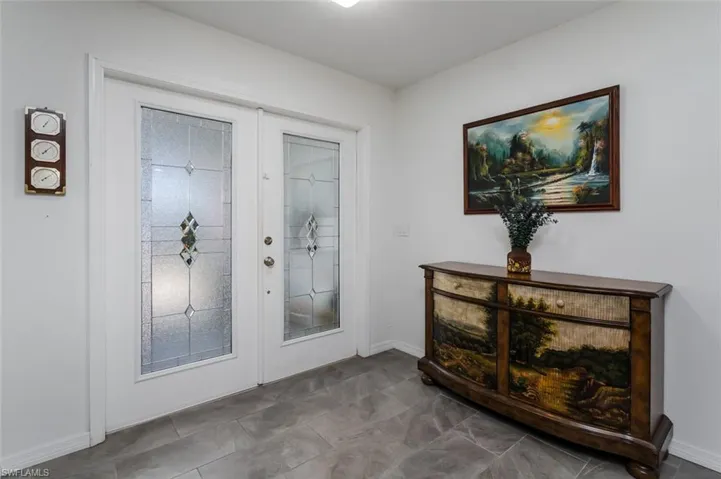 Doorway to outside with baseboards and french doors