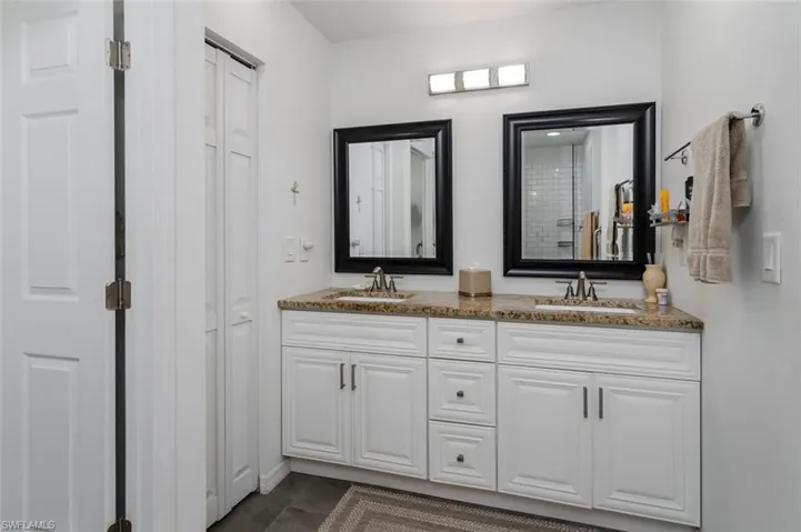 Primary Full bathroom with double vanity and a closet
