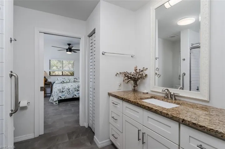 Bathroom with vanity, ensuite bathroom, and a shower with shower door