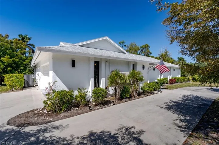 Home featuring stucco siding, concrete driveway, a garage, and roof with shingles