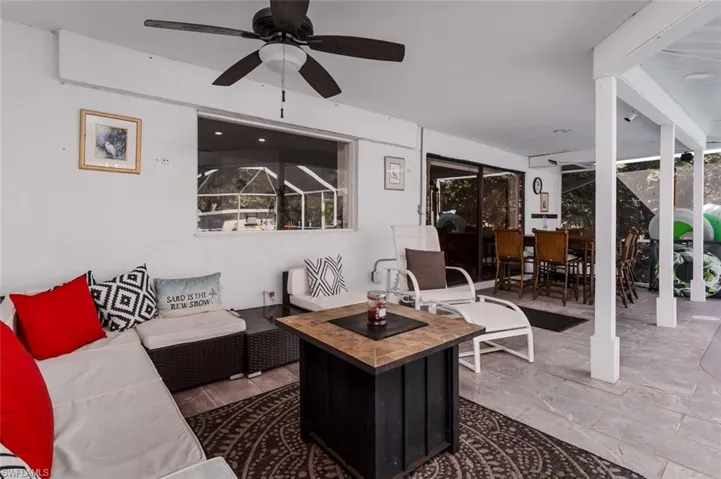 View of patio / terrace with a ceiling fan and outdoor living / dining area