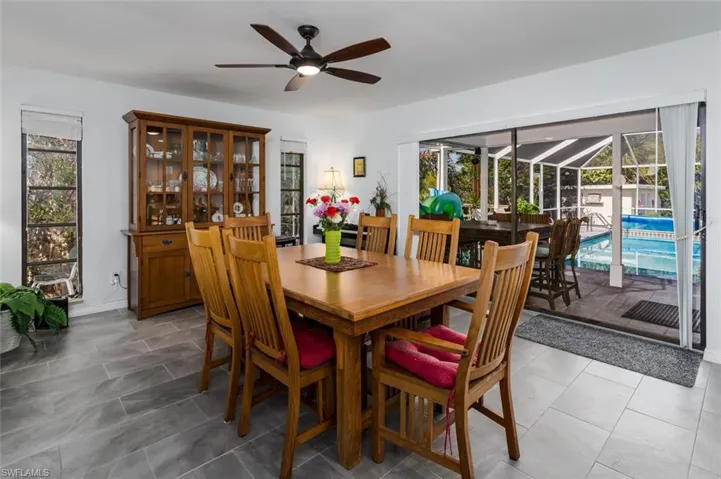 Dining room with a ceiling fan, healthy amount of natural light.