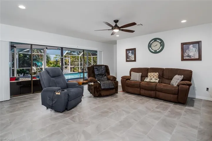 Living room with a ceiling fan and recessed lighting