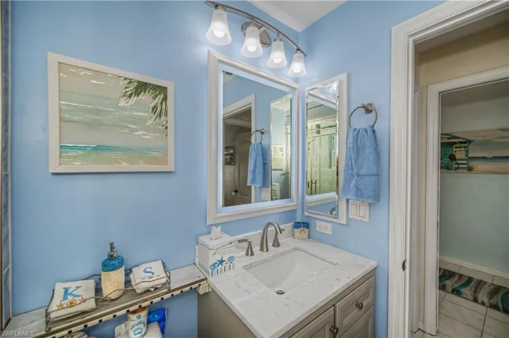 Bathroom vanity featuring a single sink, light-toned countertop, and undermount basin