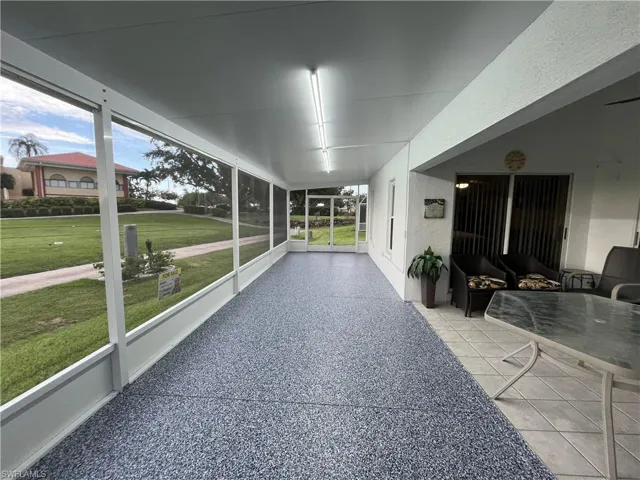 Screened enclosure with textured flooring and overhead lighting