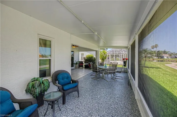 Covered patio featuring an epoxy-coated concrete floor and screen enclosure