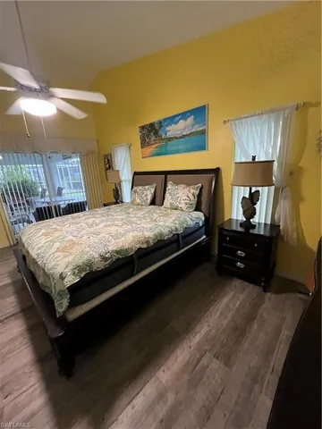 Spacious room featuring vaulted ceilings and wood-finish flooring