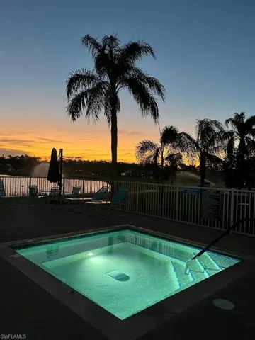 Illuminated spa with integrated steps and a surrounding concrete deck