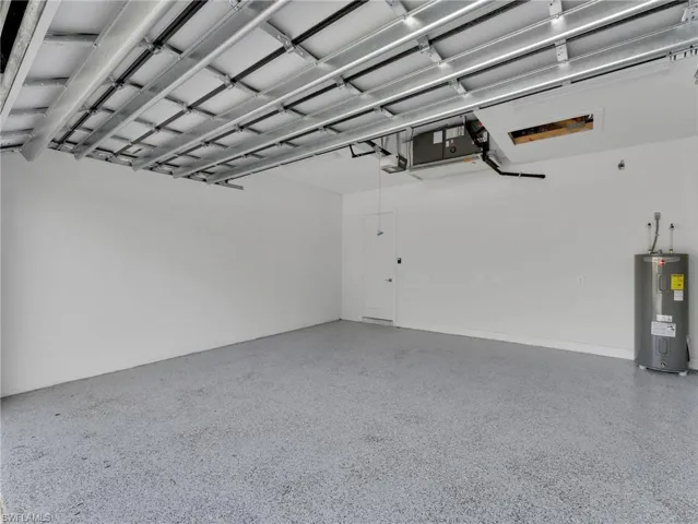 Garage with water heater and a garage door opener