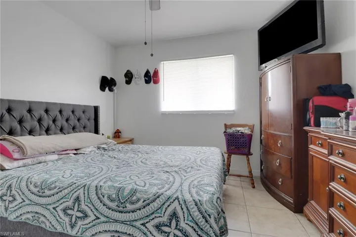 Bedroom featuring light tile patterned flooring and ceiling fan