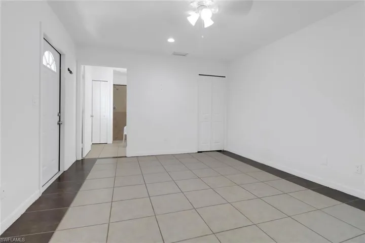 Unfurnished bedroom featuring light tile patterned floors, a closet, recessed lighting, and ceiling fan