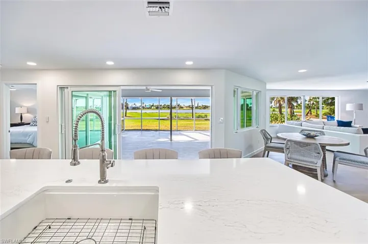Kitchen with view from island to golf course and water feature