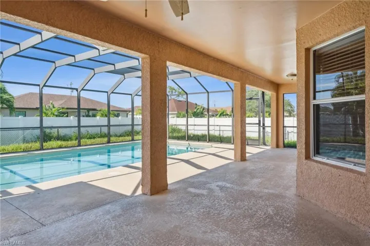 View of pool with a lanai and a patio area