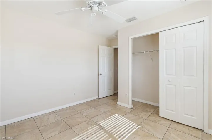Unfurnished bedroom featuring ceiling fan and a closet