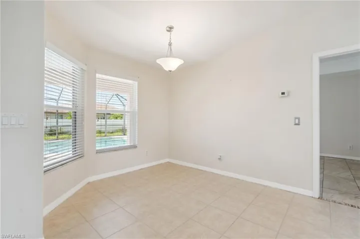 Empty room with light tile patterned floors