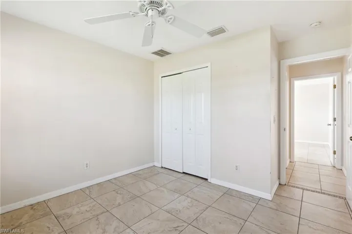 Unfurnished bedroom featuring a closet and ceiling fan